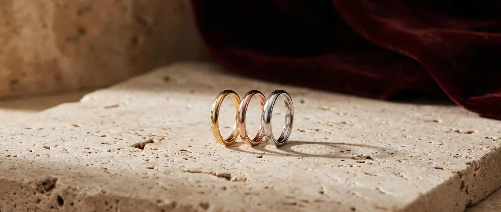 Three plain rings in yellow gold, rose gold and platinum side by side
