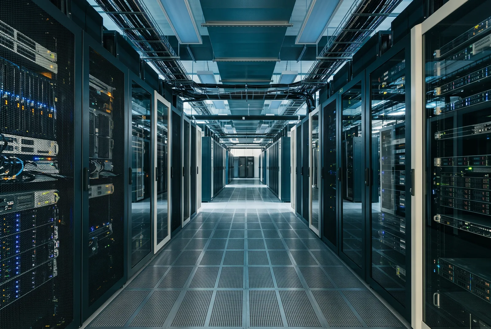 Rows of server racks in a data centre lit in blue