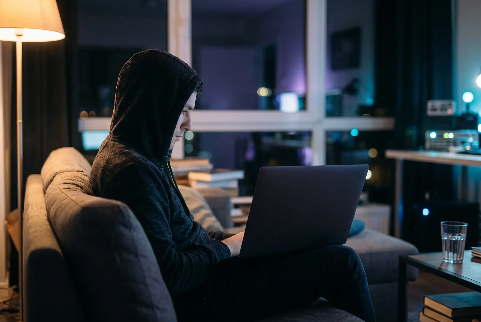 Engineer at home in the evening checking a laptop, calm